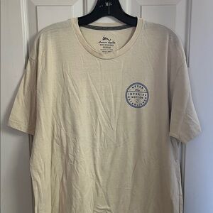 Imperial motion cream colored tee with blue logo designs. XL.